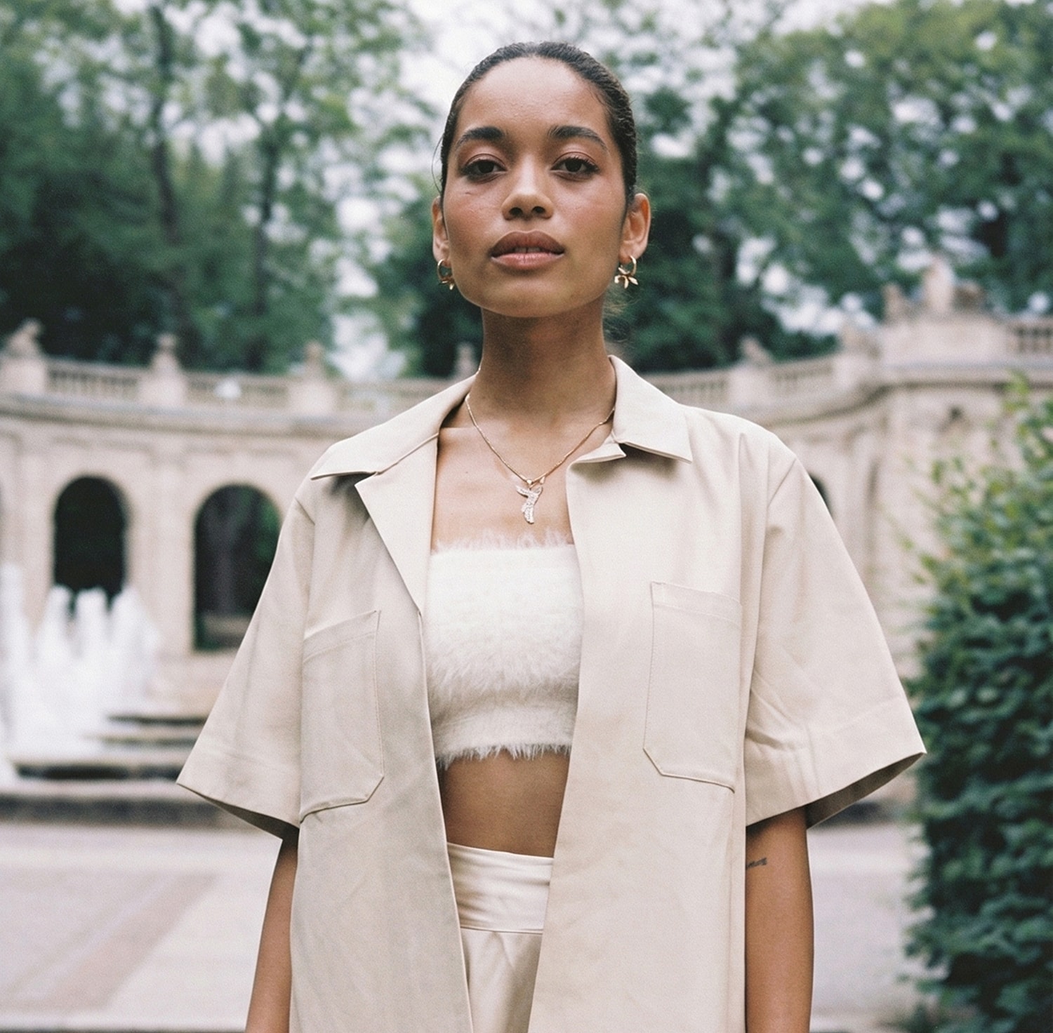 Portrait of a woman in a park setting.