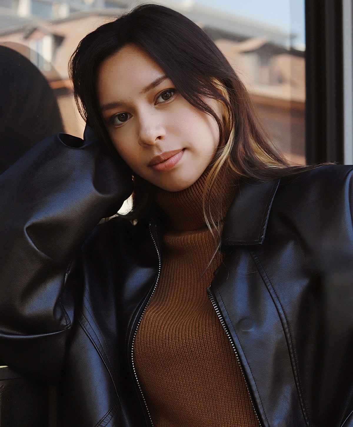 Young woman in a black leather jacket.