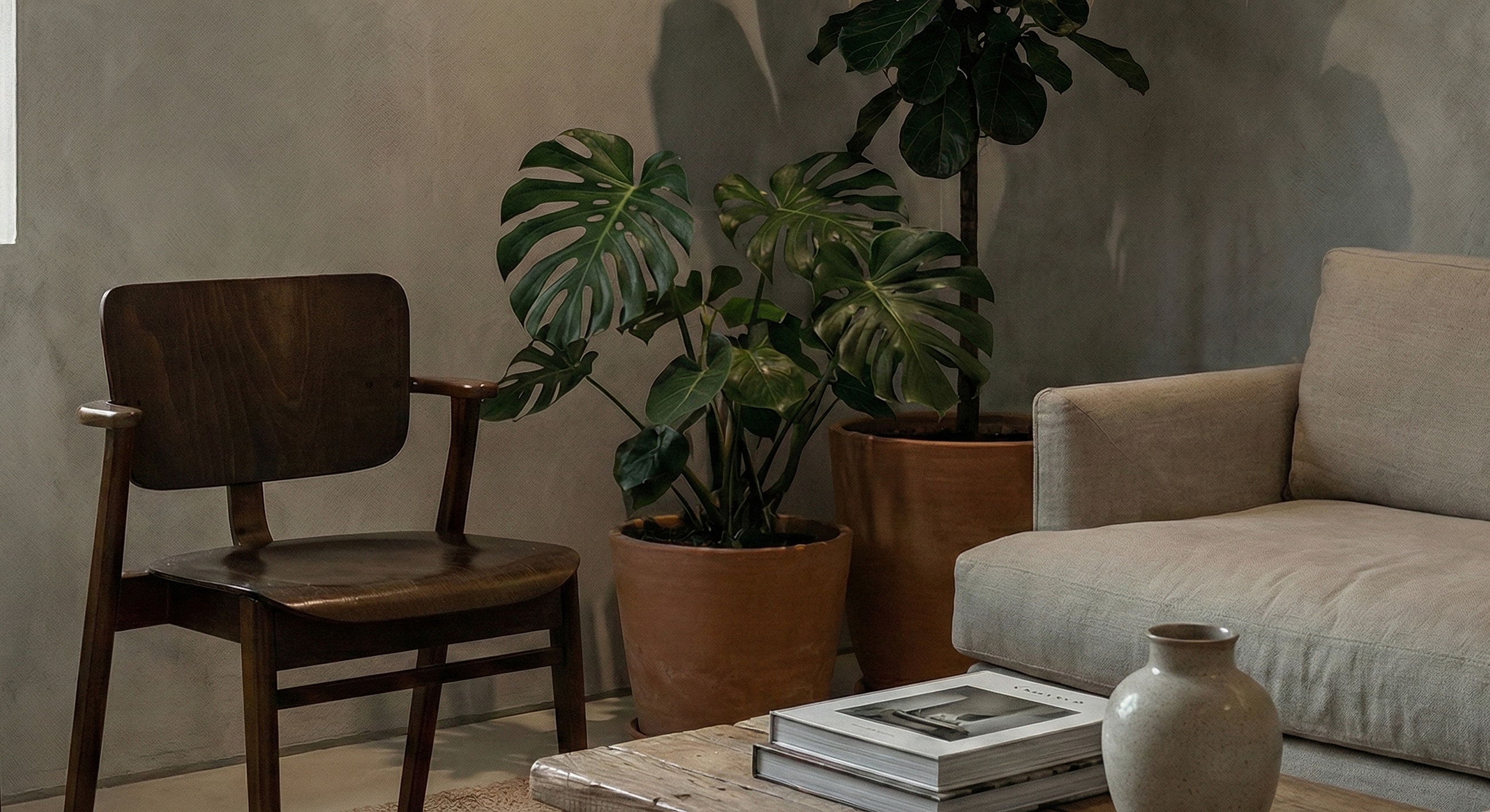 Cozy living room with plants and wooden furniture.