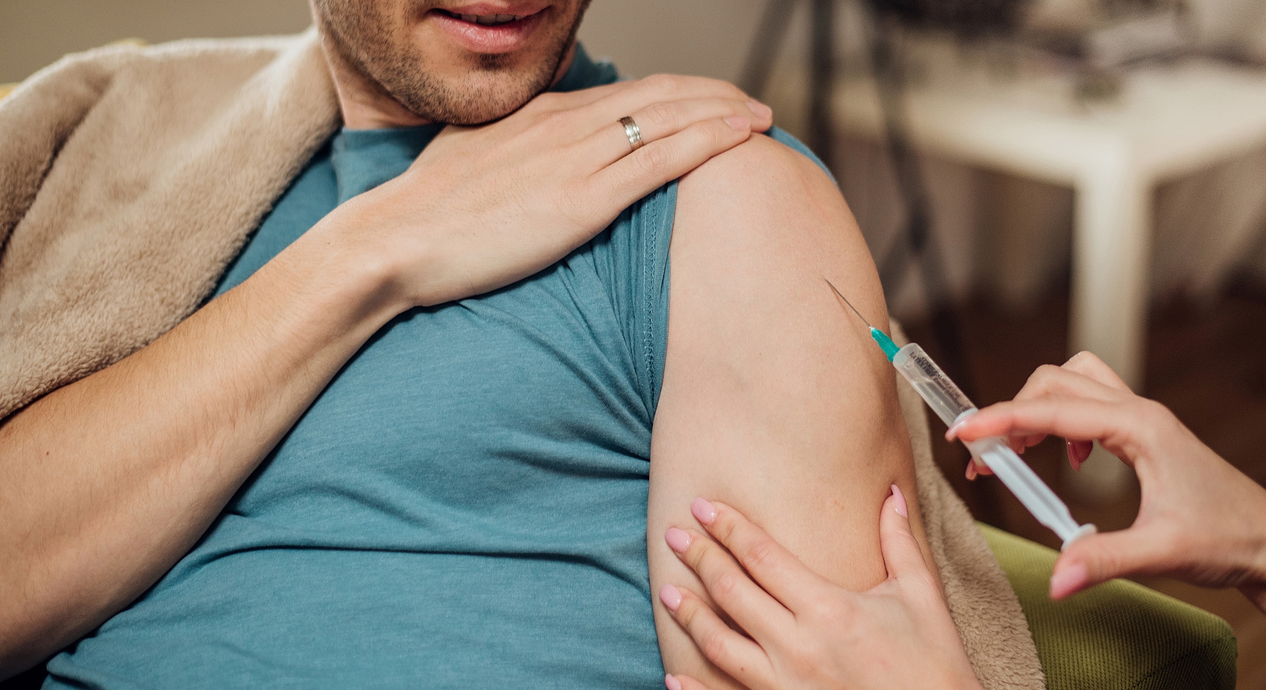 Person receiving an injection on their arm.